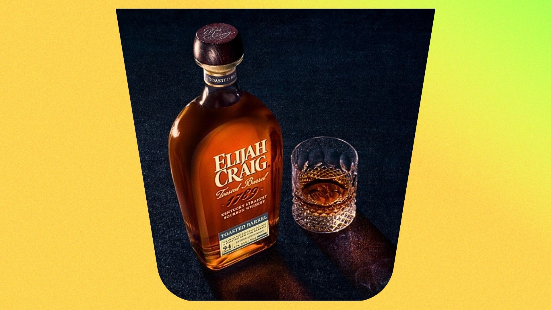 an image of the elijah craig toasted barrel bottle next to a whisky glass with a double dram poured inside a yellow background