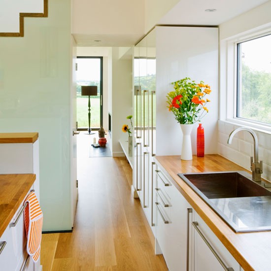 kitchen room with metal sink white wall