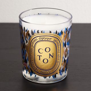 scented candle with gold and blue packaging