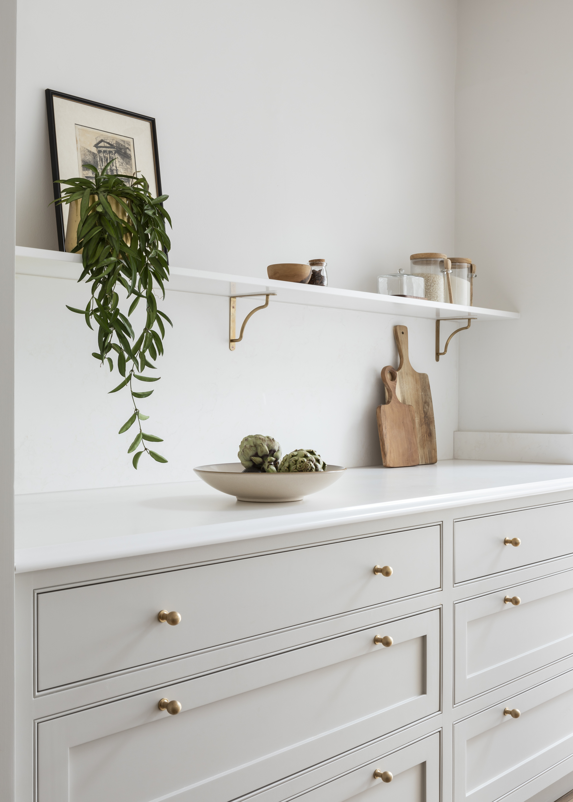 A kitchen with inset slim shaker cabinetry and a quartz countertop with an ogee edge