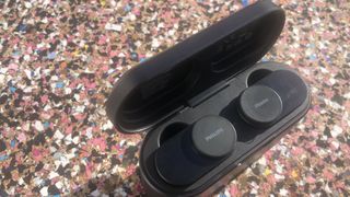 the philips fidelio t1 earbuds in their charging case