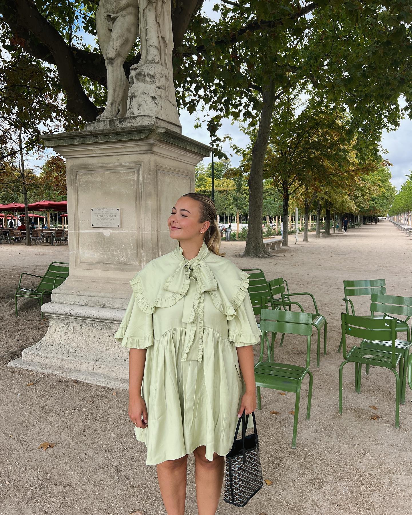 Influencer styles a green mini dress.
