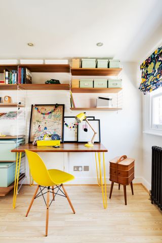 home office with handy storage solution and bright yellow chair photographed by Bruce Hemming