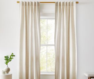 Linen curtains against a white wall.
