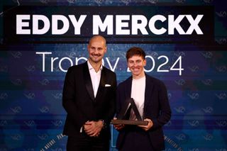 Slovenian rider Tadej Pogacar (R) receives the Eddy Merckx men's trophy from Belgian rider Tom Boonen (L) during the 2024 Velo d'Or award ceremony at the Pavillon Gabriel in Paris on December 6, 2024. (Photo by Anne-Christine POUJOULAT / AFP)