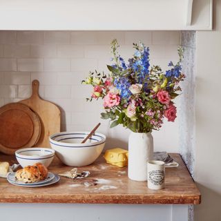 a hand tied bouquet of country flowers on a kitchen table