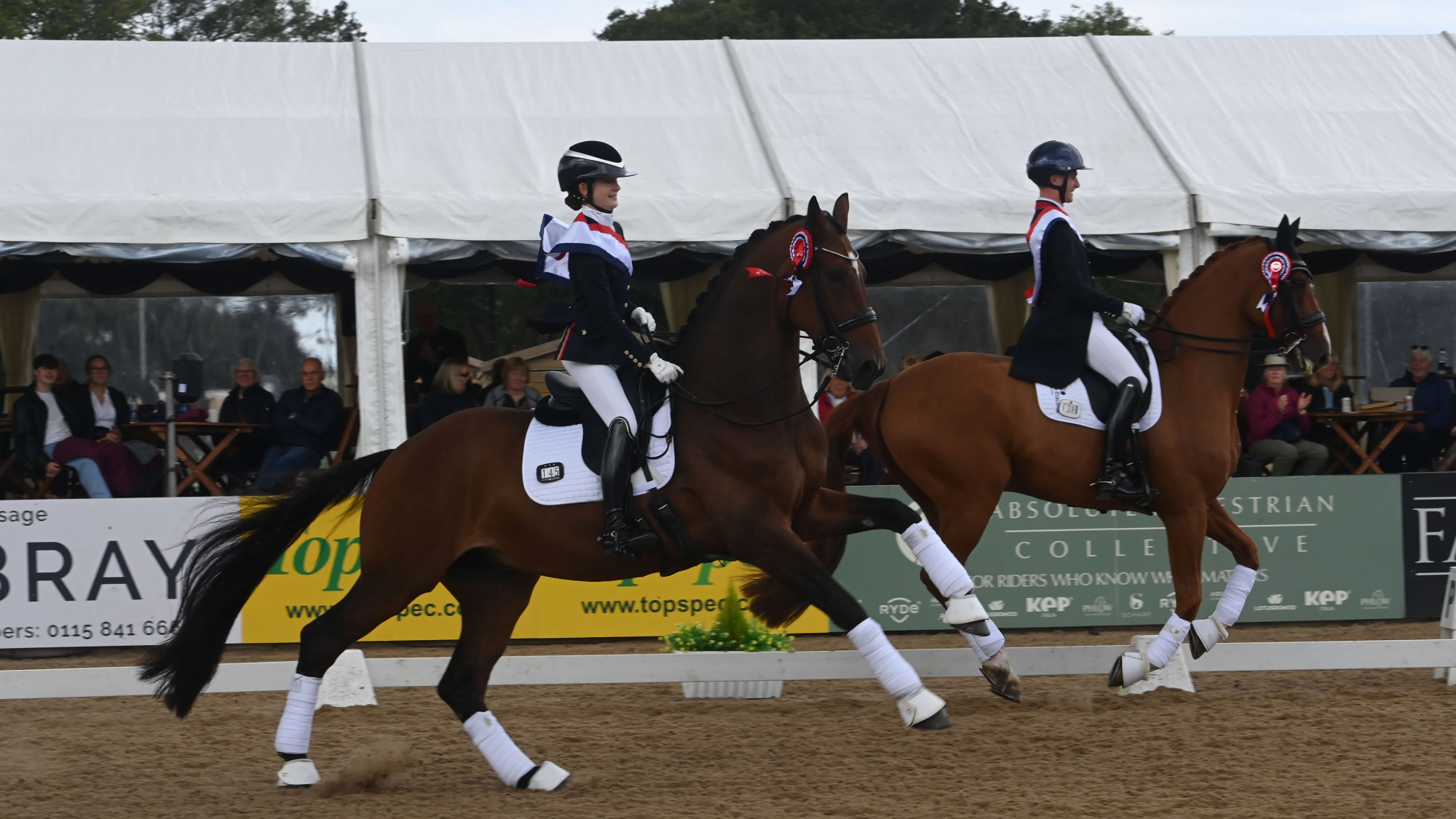 Abigail Gray and Jack Diamond lead Myles Graham and Fred Astaire WD in canter during the prize-giving at the LeMieux National Dressage Championships