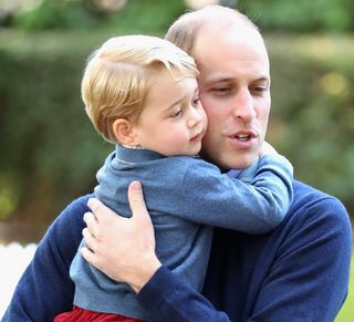 Prince George of Cambridge with Prince William, Duke of Cambridge at a children's party for Military families during the Royal Tour of Canada