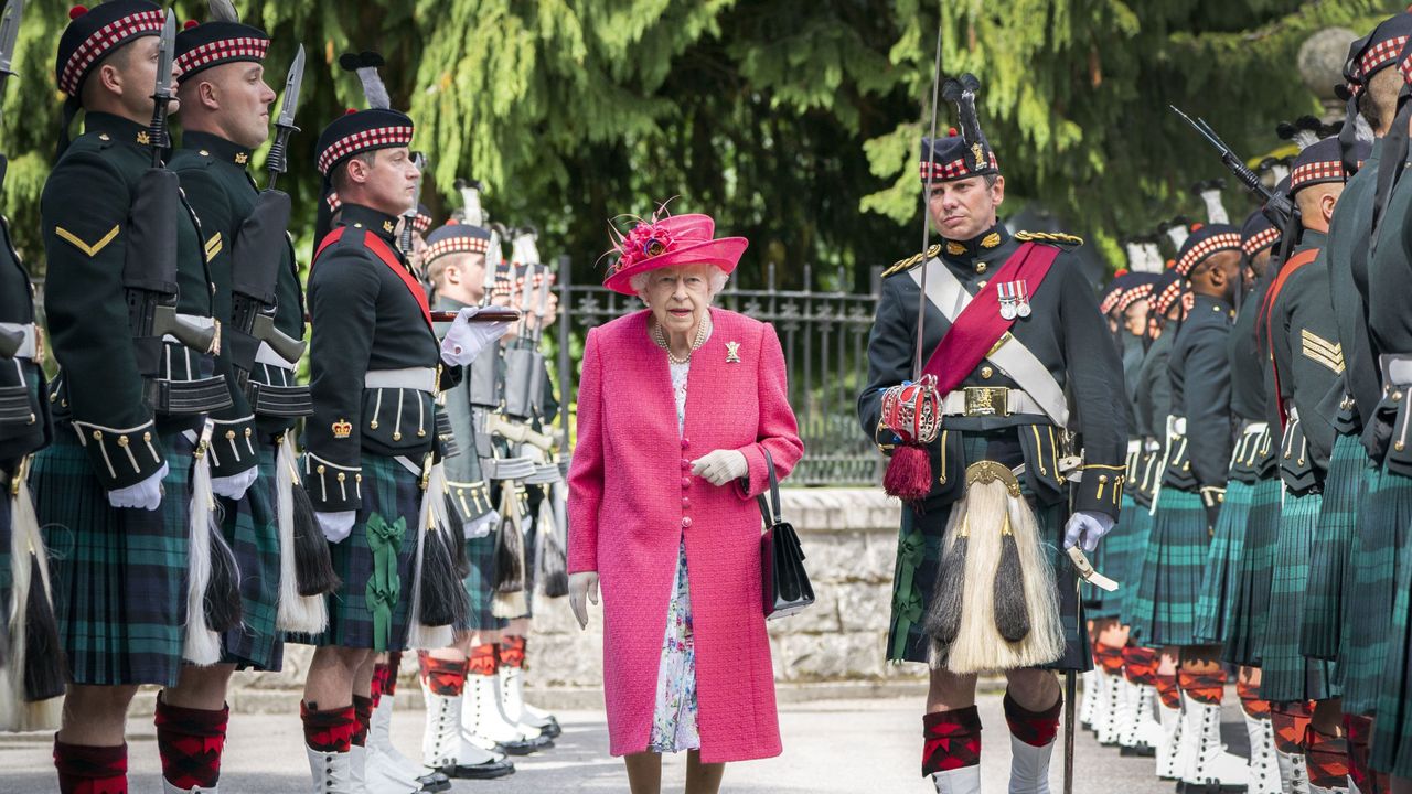 Queen Elizabeth II inspects soldiers from the Royal Regiment of Scotland