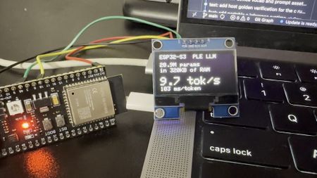 A photo of an ESP32 microcontroller wired up to a small screen showing AI benchmark results.