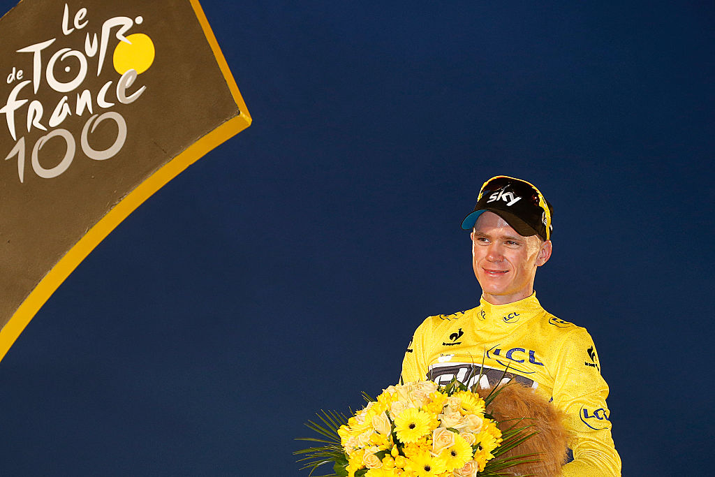 Tour de France 2013 winner Britain's Christopher Froome poses on the podium in Paris on the Champs-Elysees avenue, at the end of the 133.5 km twenty-first and last stage of the 100th edition of the Tour de France cycling race on July 21, 2013 between Versailles and Paris. AFP PHOTO / JOEL SAGET (Photo by JOEL SAGET / AFP)