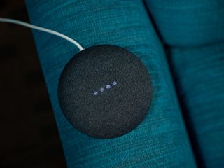 A Google Home Nest Mini Speaker on a blue backdrop