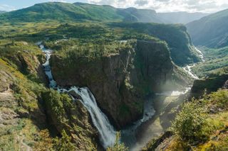 An aerial view showing the powerful Voringfossen Waterfall cascading down a mountainside in Norway