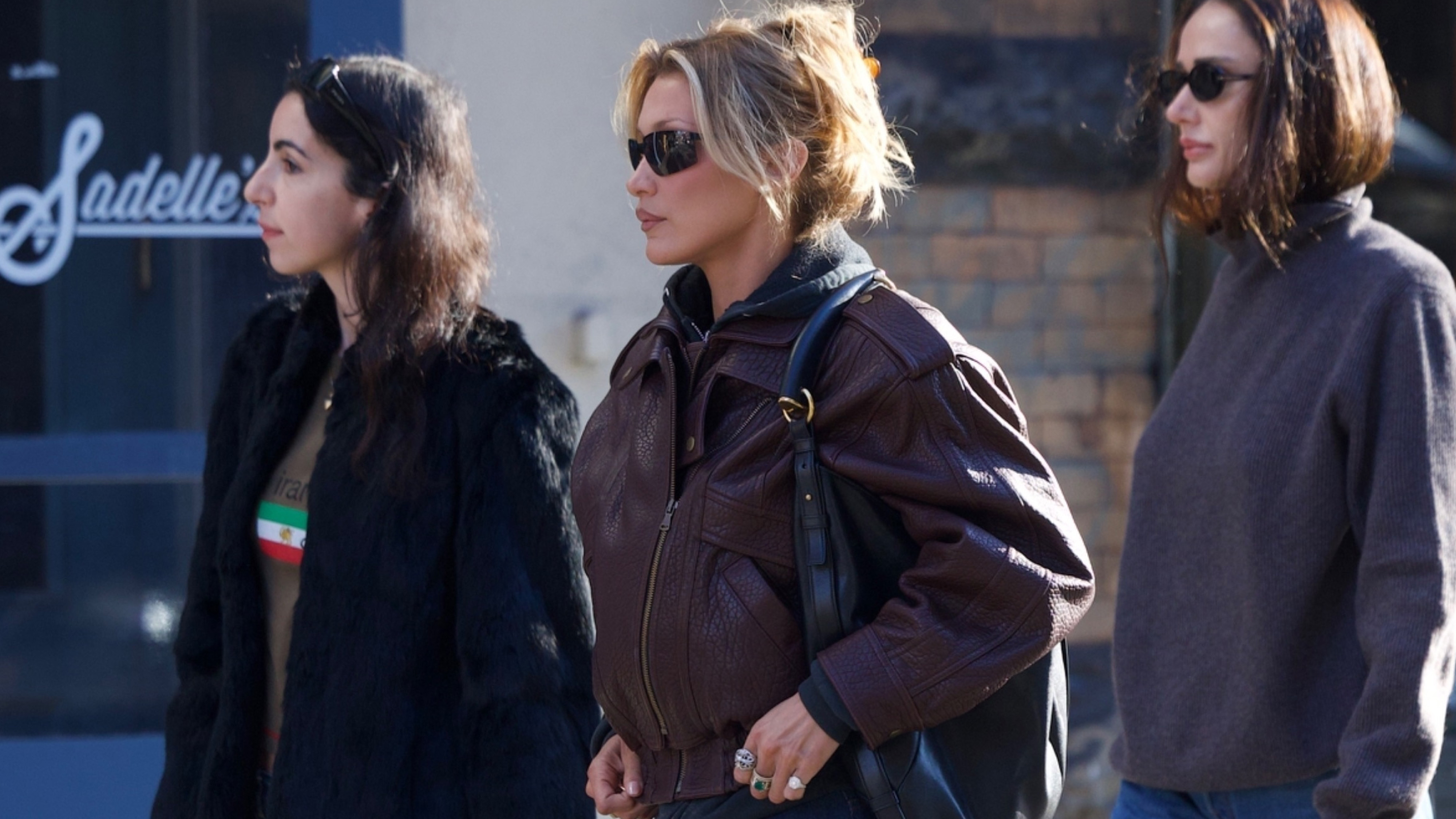 Bella Hadid was spotted at breakfast at Sadelle's in Soho on Monday afternoon with friends. The model wore a maroon leather biker jacket from Drejani, which she styled over a gray hoodie, with dark denim straight-leg jeans and Salomon sneakers. She finished her look with a Saint Laurent Mombasa bag.