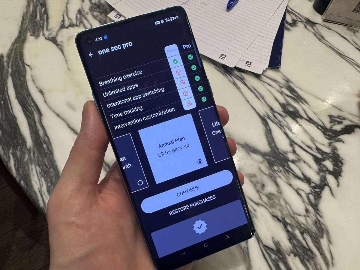 One Sec app, open on Android smartphone against marble table.