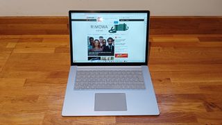 Microsoft Surface Laptop 5 review; a silver chrome laptop on a wooden desk