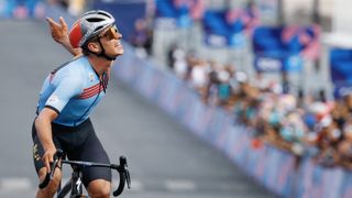 Belgium&#039;s Remco Evenepoel celebrates as he cycles to cross the finish line to win the men&#039;s cycling road race during the Paris 2024 Olympic Games in Paris, on August 3, 2024. (Photo by Odd ANDERSEN / AFP) (Photo by ODD ANDERSEN/AFP via Getty Images)