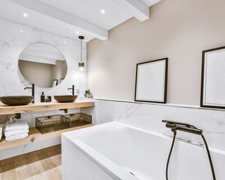 Small bathroom with white tub and black features