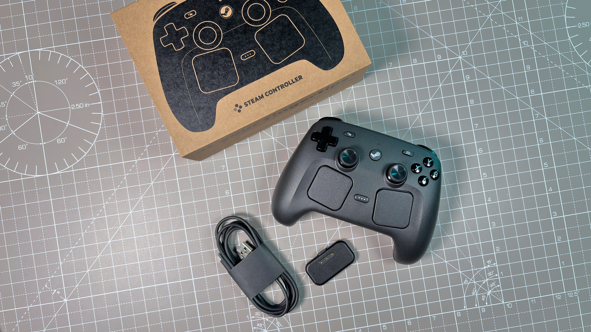 The Steam Controller on a desk during a teardown, with various parts removed.