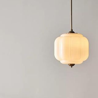 A vintage-style pendant light with gold accents