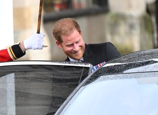 Prince Harry seen entering a car as he exits the Coronation ceremony at Westminster Abbey