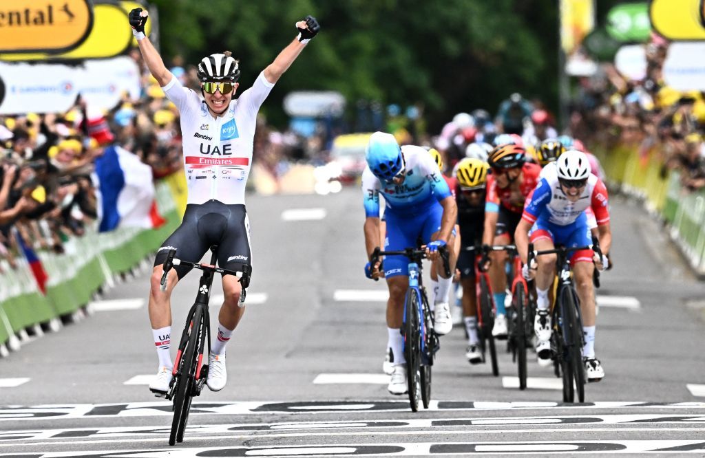 UAE Team Emirates teams Slovenian rider Tadej Pogacar L celebrates as he cycles to the finish line to win the 6th stage of the 109th edition of the Tour de France cycling race 2199 km between Binche in Belgium and Longwy in northern France on July 7 2022 Photo by AnneChristine POUJOULAT AFP Photo by ANNECHRISTINE POUJOULATAFP via Getty Images