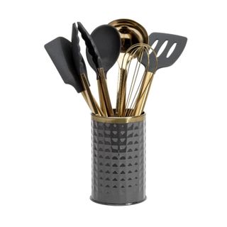 A set of black and gold kitchen utensils in a container