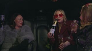 Chas and Tracy, who's wearing heart-shaped red glasses, in the back of the limo