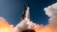 a large silver rocket launches above a plume of fire