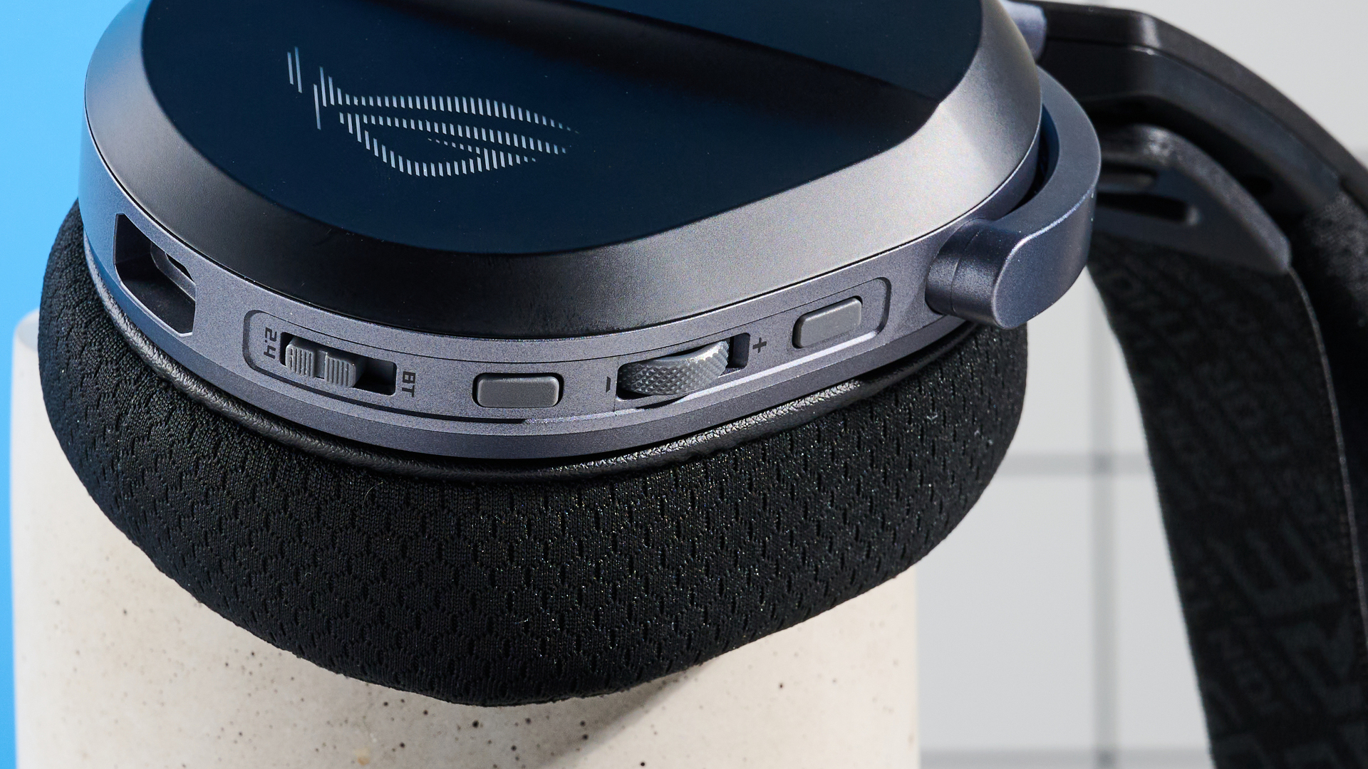 A black Asus ROG Pelta gaming headset with a detachable mic and RGB lighting