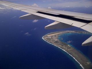 Orbital Science Corp.'s L-1011 aircraft "Stargazer" flies over the runway on Kwajalein Atoll, which is home to the island of Roi-Namur.