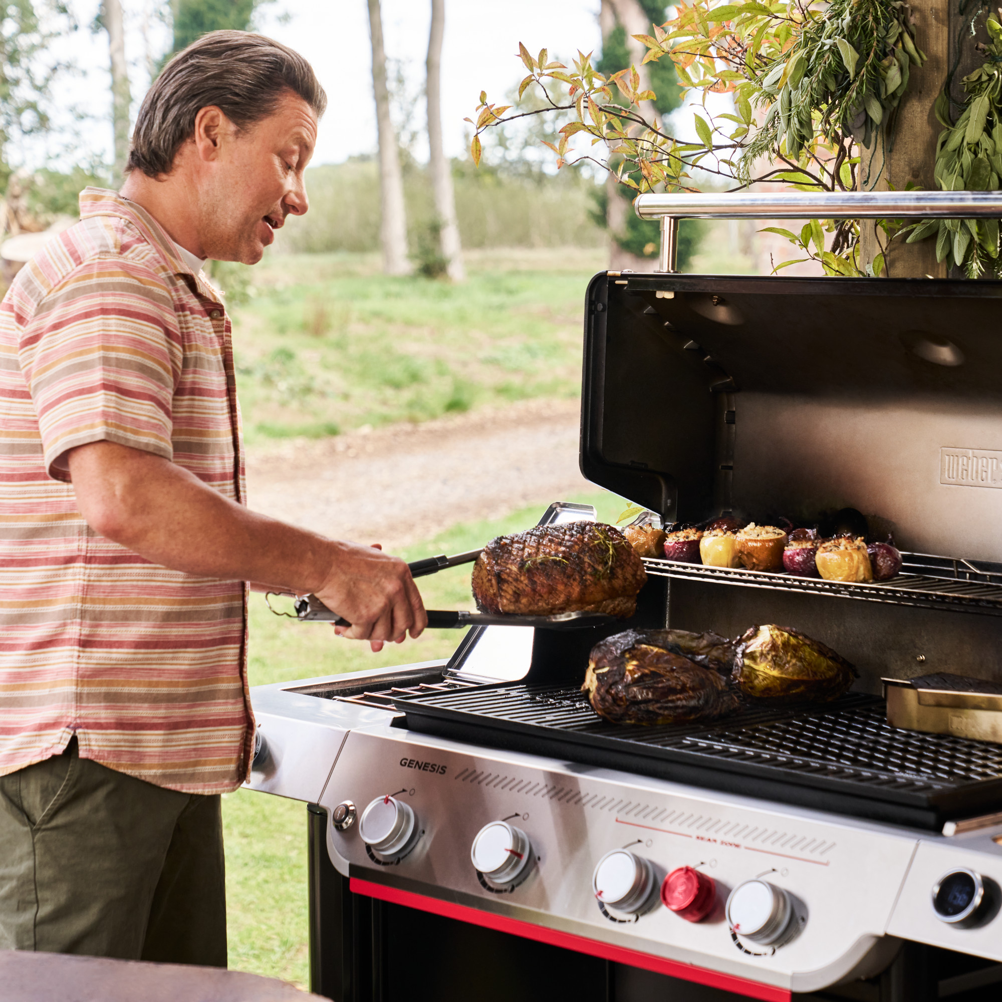 Jamie Oliver cooking on a Weber Genesis EP-435w barbecue