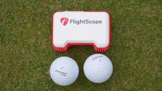 flightscope mevo launch monitor size next to two golf balls
