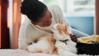 Woman and cat looking adoringly at one another