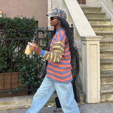 Influencer wears brown loafers.