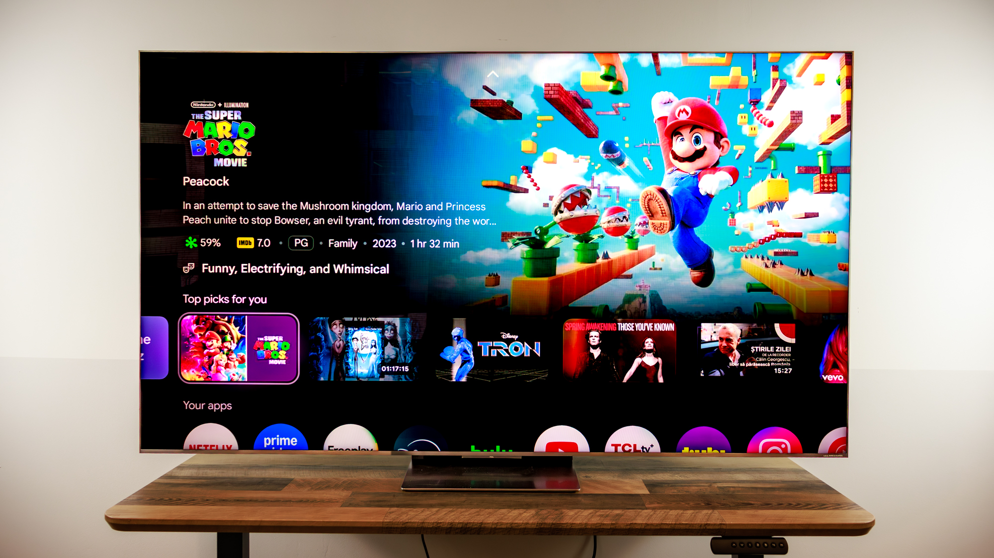 A 75-inch TCL QM8L TV on a desk