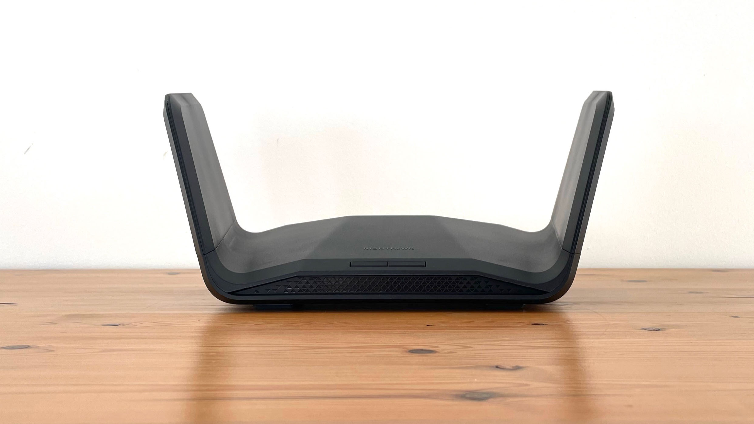 Netgear Nighthawk RAXE300 on top of a wooden desk