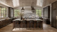 A dark wood kitchens with marble countertops and a curved glossy ceiling