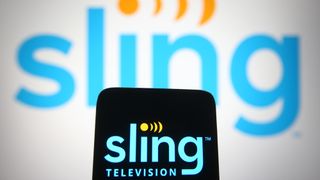 In this photo illustration Sling TV logo is seen on a mobile phone and a computer screen