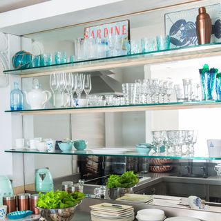 open shelving in kitchen with mirrored wall