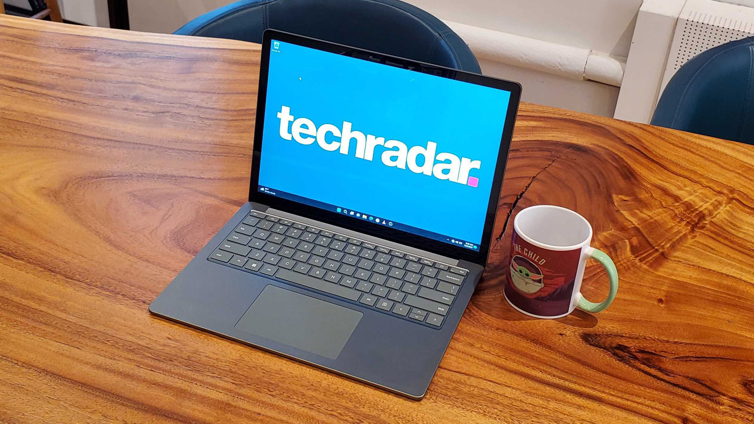 Microsoft Surface Laptop 5, in silver, on a wooden desk