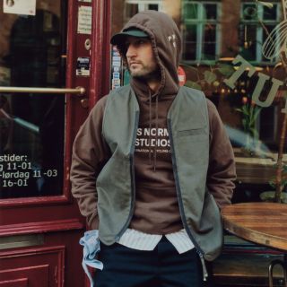 a man sat outside a cafe wearing casual cycling clothing