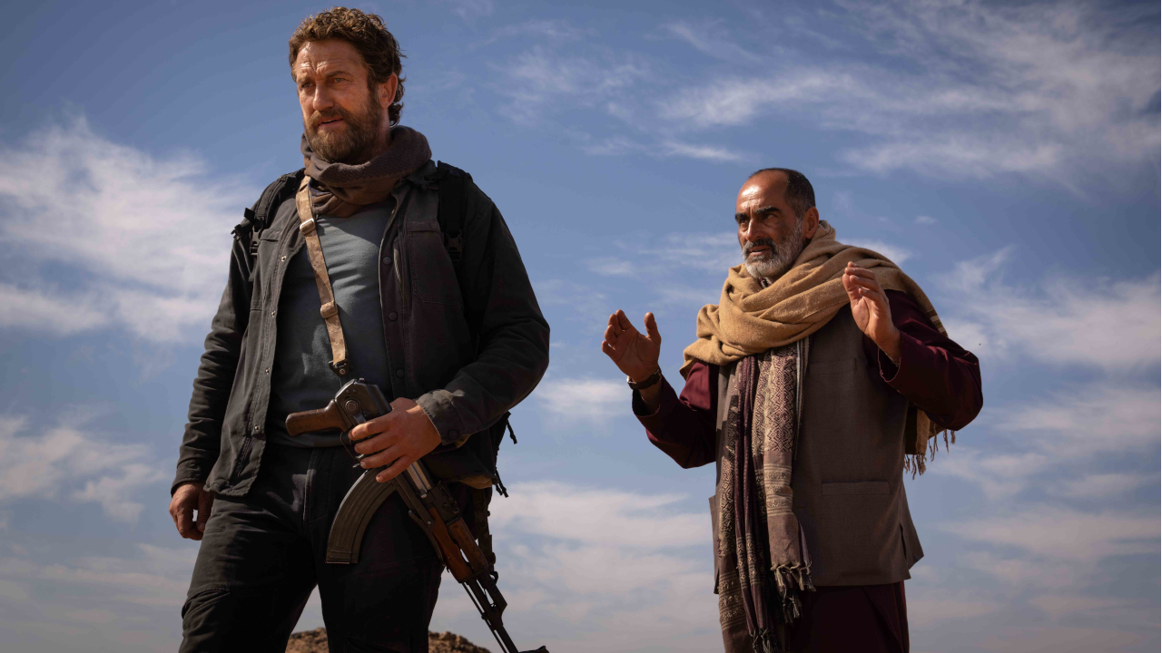 Gerard Butler and Navid Negahban stand cautiously in the open in Kandahar.
