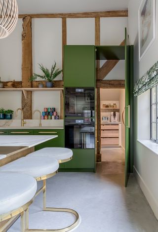 A modern rustic kitchen with a concealed door leaving to another room