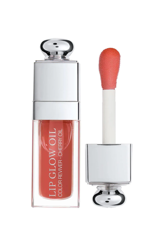 A tube of Dior Lip Glow Oil set against a white background.