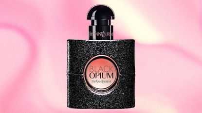 A bottle of Black Opium by YSL on a pink and cream marbled template