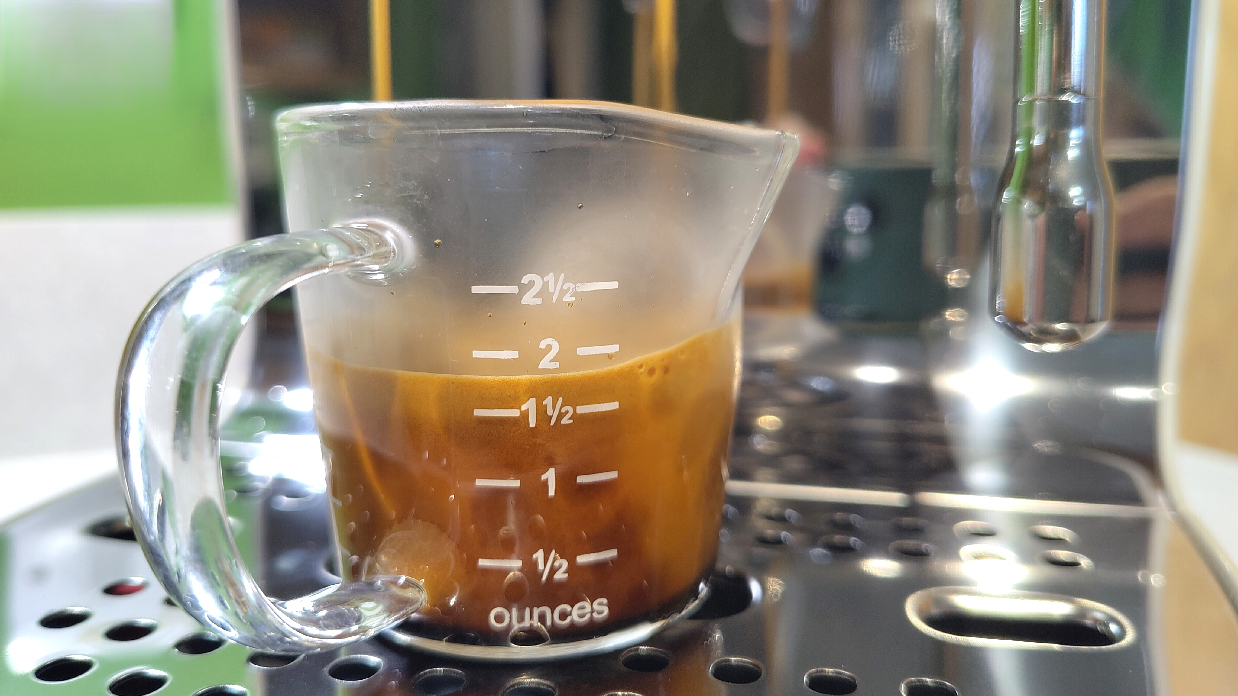 Espresso made using Smeg ECF03 espresso machine in measuring cup