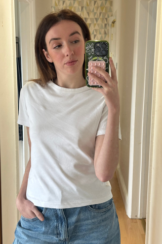 An image of Who What Wear UK social media editor, Megan Storey, wearing one of the best white t-shirts.