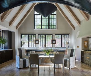 kitchen with vaulted ceiling dark cabinets range cooker and big pendant light