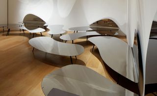 This experimental synergy continues through the room, across the ’Even the Oddballs’ chairs, ’Tuba’ steel sofa and, finally, the ’Puddles’ series of coffee tables (pictured) that crawl along the floor,